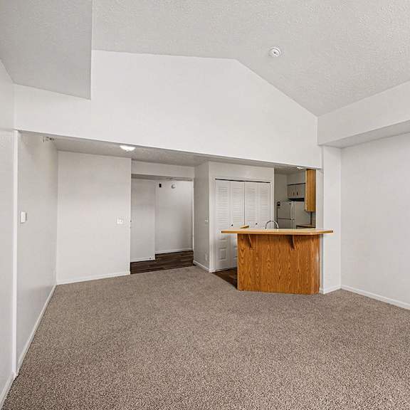 Thumbnail 7 of 19 A dining room with a carpeted floor and a breakfast bar at Brentwood Park Apartments in LaVista, NE