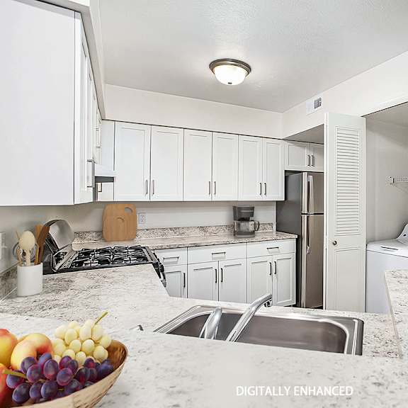 Thumbnail 9 of 14 A kitchen with a full size washer and dryer at Brentwood Park Apartments, La Vista, 68128