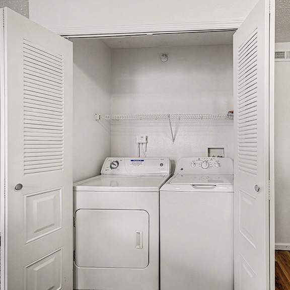 Thumbnail 13 of 19 A laundry area with a washer and dryer at Brentwood Park Apartments in LaVista, NE
