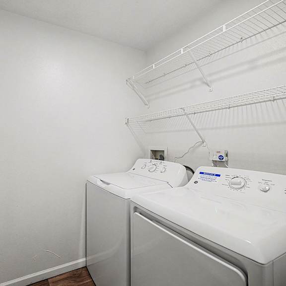 Thumbnail 12 of 20 A laundry room with a full size washer and dryer at Brentwood Park Apartments in LaVista, NE