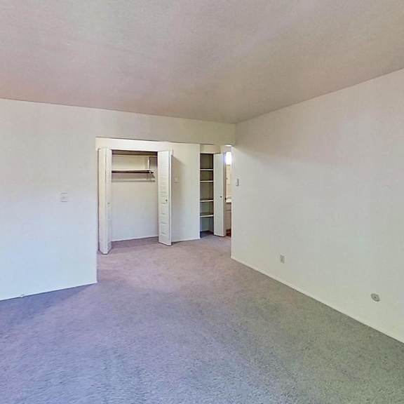 Thumbnail 6 of 10 A large empty living and dining room with a closet at Briarwood Apartments in Benton Harbor, MI