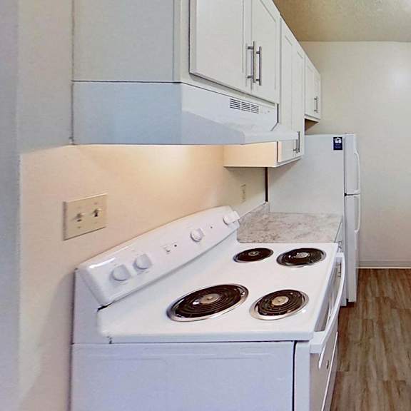 Thumbnail 6 of 12 A kitchen with white cabinets and appliances at Briarwood Apartments in Benton Harbor, MI