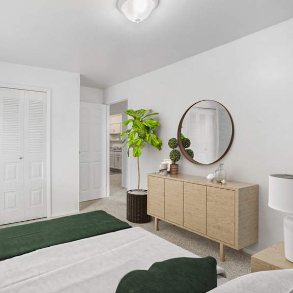 Thumbnail 9 of 13 A bedroom with a bed, dresser, mirror and a closet at Brookside Apartments, Springfield