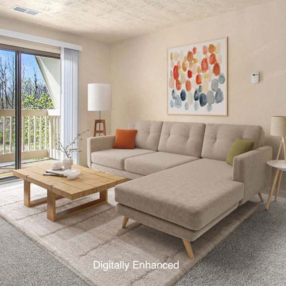 Thumbnail 3 of 8 A living room with a couch, a coffee table and a slider to a balcony at Brookside Apartments, Springfield, MI.