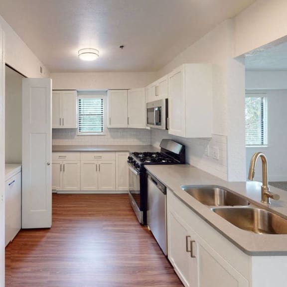 Thumbnail 8 of 14 A kitchen with stainless steel appliances at Byron Lakes Apartments, Byron Center, MI, 49315