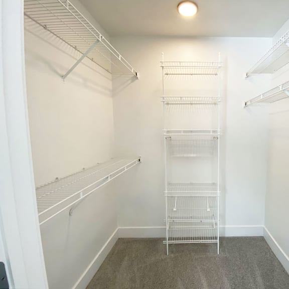 Thumbnail 10 of 15 bedroom walk in closet with wardrobe organizers at The Crossings Apartments, Michigan, 49508