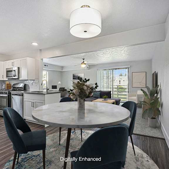 Thumbnail 3 of 14 A modern kitchen and dining room with a dining table set for four at Byron Lakes Apartments, Michigan, 49315