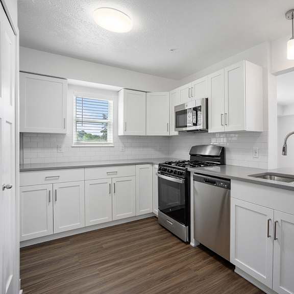 Thumbnail 7 of 14 A kitchen with stainless steel appliances at Byron Lakes Apartments, Byron Center, MI, 49315