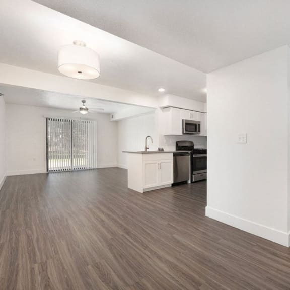 Thumbnail 4 of 19 dining and living rooms with hard surface flooring at Byron Lakes Apartments in Byron Center, MI