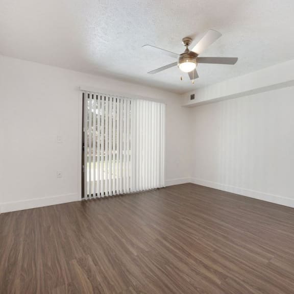 Thumbnail 5 of 19 living room with a ceiling fan at Byron Lakes Apartments in Byron Center, MI