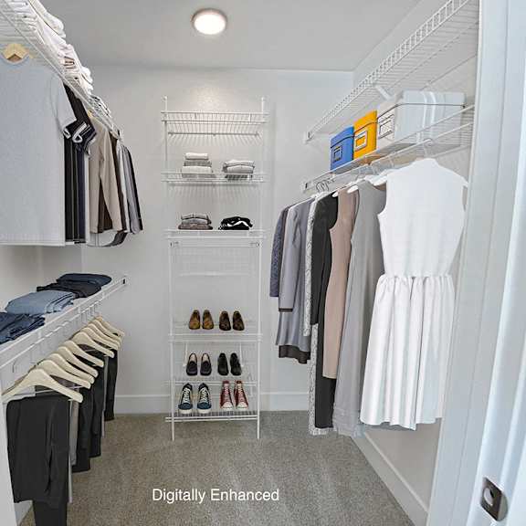 Thumbnail 19 of 24 a walk in closet with wardrobe organizers at Byron Lakes Apartments in Byron Center, MI