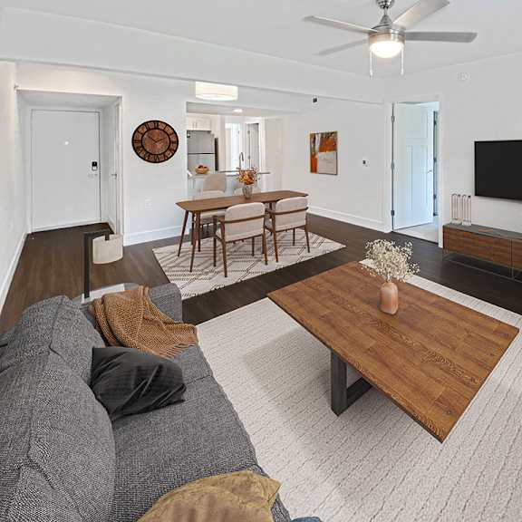 Thumbnail 8 of 17 A living room with a grey couch and a wooden coffee table at Byron Lakes Apartments, Michigan, 49315