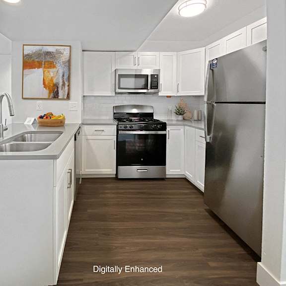 Thumbnail 11 of 24 a kitchen with white cabinets and stainless steel appliances at Byron Lakes Apartments in Byron Center, MI