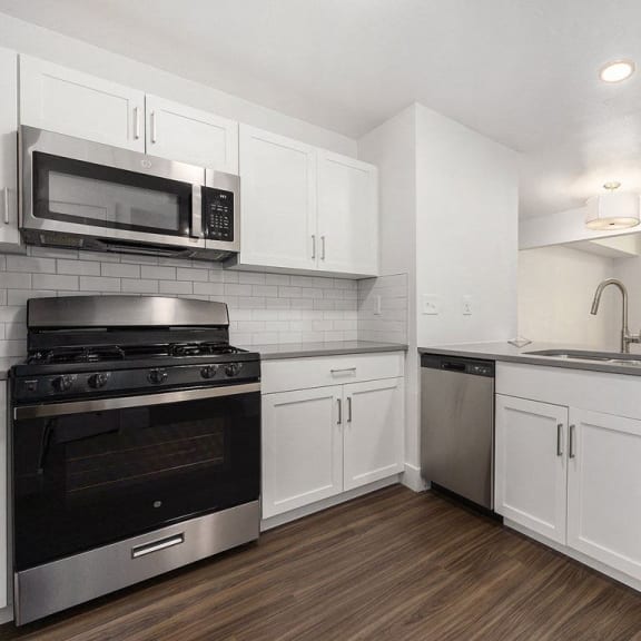 Thumbnail 13 of 24 a kitchen with a view of a slider to a balcony at Byron Lakes Apartments in Byron Center, MI