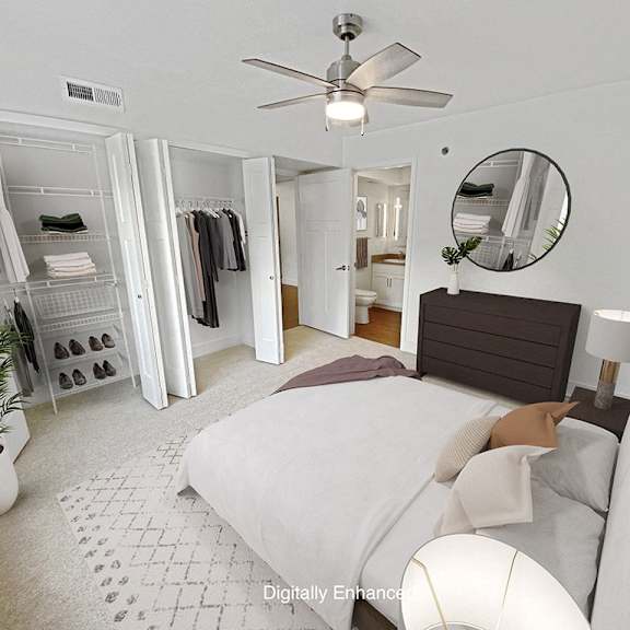 Thumbnail 21 of 24 bedroom with a large closet door and attached bath at Byron Lakes Apartments in Byron Center, MI