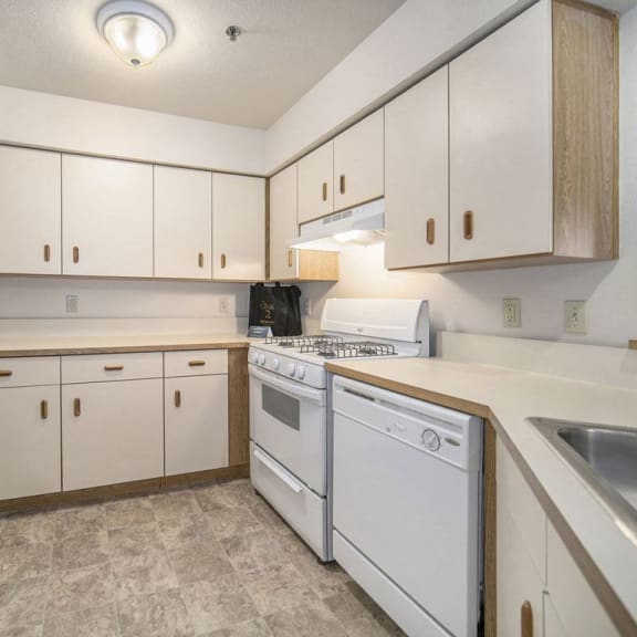 Thumbnail 6 of 11 Kitchen with white appliances at Canal 2 Apartments, Lansing, MI