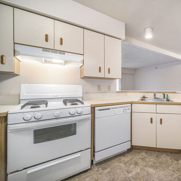 Thumbnail 7 of 11 a kitchen with a breakfast bar at Canal 2 Apartments in Lansing, MI