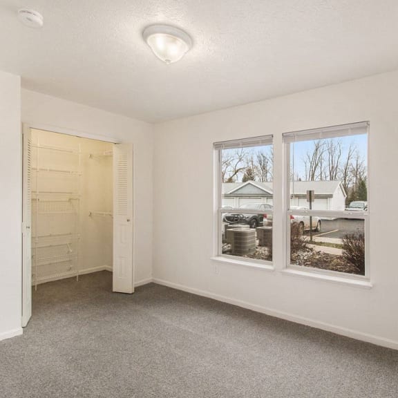 Thumbnail 11 of 16 bedroom with two large windows and a walk in closet at Canal 2 Apartments in Lansing, MI