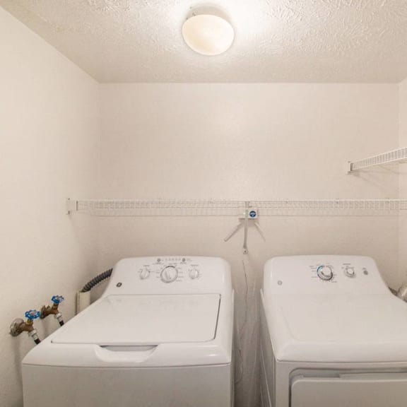 Thumbnail 10 of 16 a laundry room with full size washer and dryer at Canal 2 Apartments in Lansing, MI