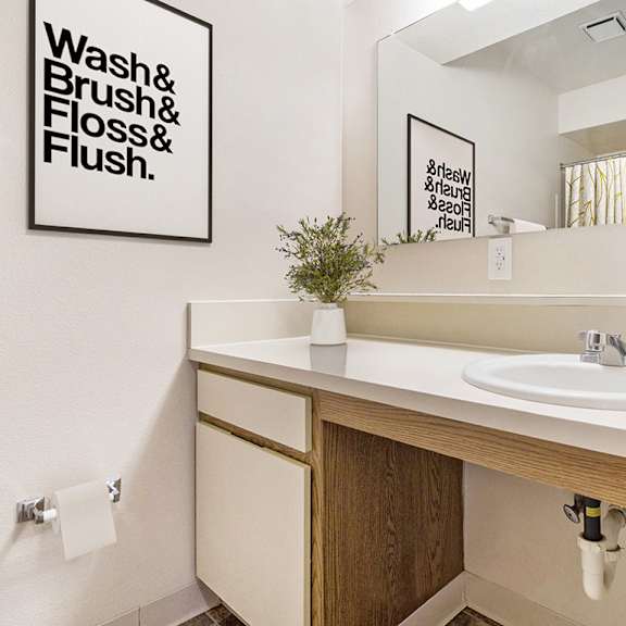 Thumbnail 9 of 12 A bathroom with a large vanity at Canal Club Apartments, Lansing, 48917