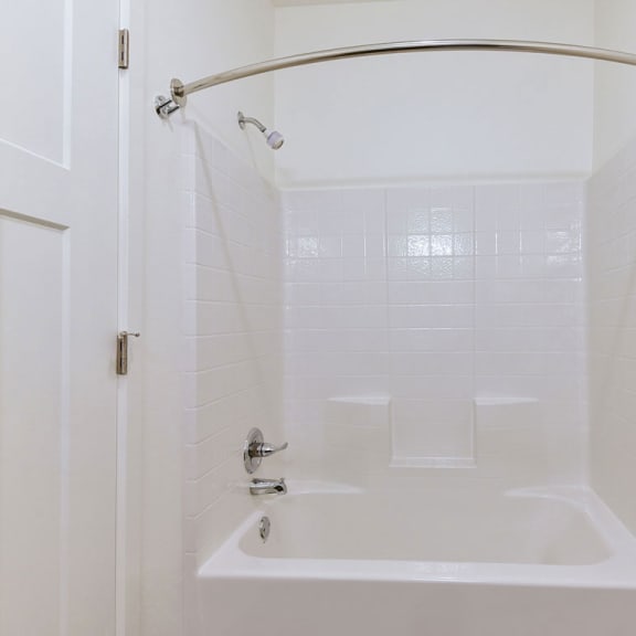 Thumbnail 15 of 18 A bathtub and shower at Chase Creek Apartment Homes, Alabama, 35811