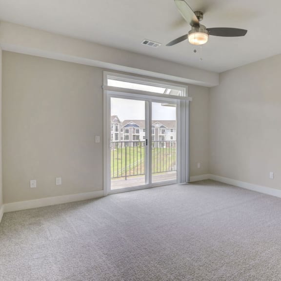 Thumbnail 7 of 18 A living room with a 9 foot ceiling and a ceiling fan at Chase Creek Apartment Homes, Huntsville, Alabama