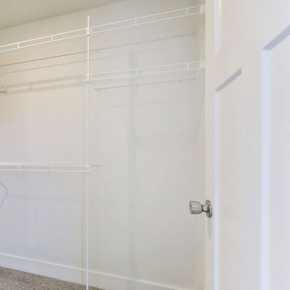 Thumbnail 10 of 12 A walk in closet with wardrobe organizers at Chase Creek Apartment Homes, Huntsville, 35811