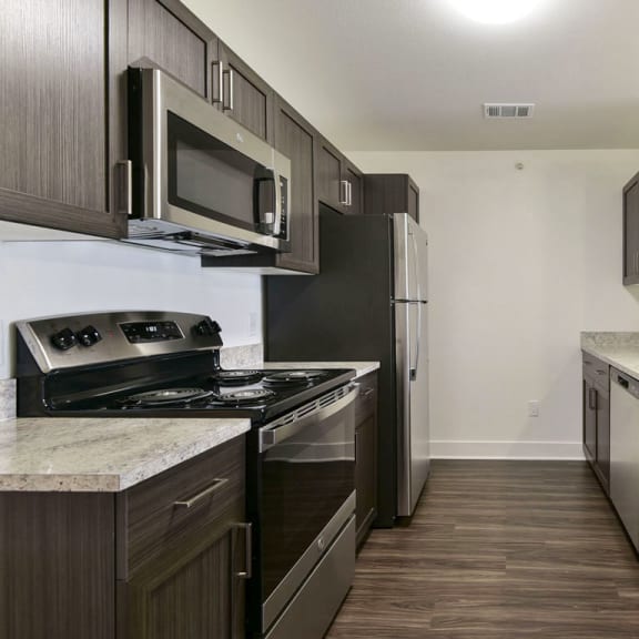 Thumbnail 6 of 12 A kitchen with stainless steel appliances at Chase Creek Apartment Homes, Huntsville, AL