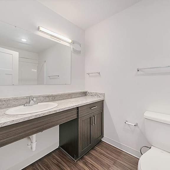 Thumbnail 14 of 18 A bathroom next to a sink and mirror at Chase Creek Apartment Homes, Huntsville, 35811