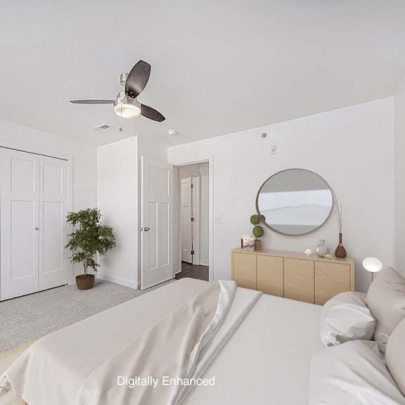 Thumbnail 16 of 18 A bedroom with a bed, dresser, mirror, and a ceiling fan at Chase Creek Apartment Homes, Huntsville, 35811
