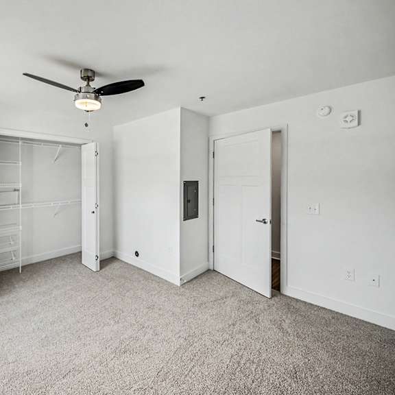 Thumbnail 13 of 13 A bedroom with a ceiling fan, walk-in closet and carpeted floor at Chase Creek Apartment Homes, Huntsville, AL, 35811