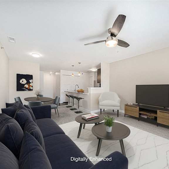 Thumbnail 5 of 18 A living room with a dark blue sofa and a ceiling fan at Chase Creek Apartment Homes, Huntsville, 35811