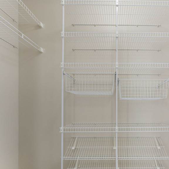 Thumbnail 6 of 6 A walk-in closet with wardrobe organizers at Colonial Pointe at Fairview Apartments, Bellevue, NE, 68123