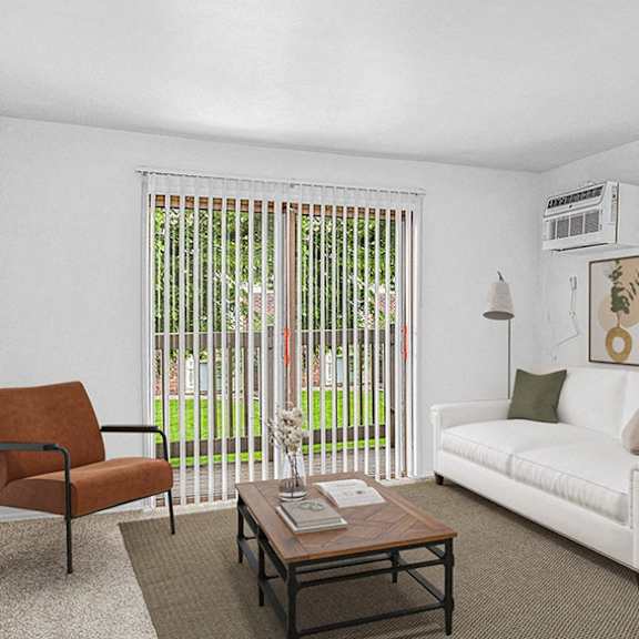 Thumbnail 3 of 10 A living room with a white couch, a brown chair, and a coffee table at Concord Place Apartments in Kalamazoo, Michigan 49009