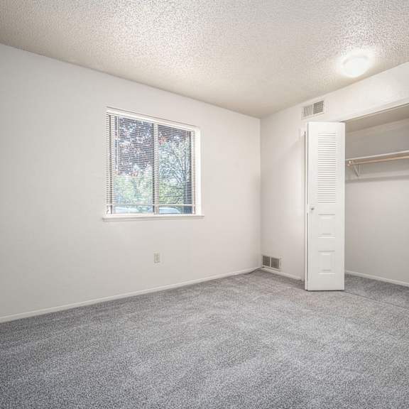 Thumbnail 13 of 14 A bright bedroom with a window and a closet at Concord Place Apartments, Kalamazoo, MI, 49009