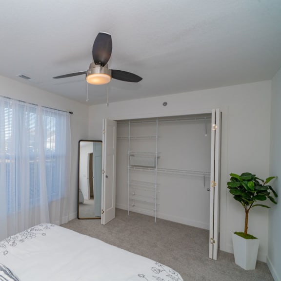 Thumbnail 15 of 15 a bedroom with a walk in closet at Copper Creek Apartment Homes, Maize, KS