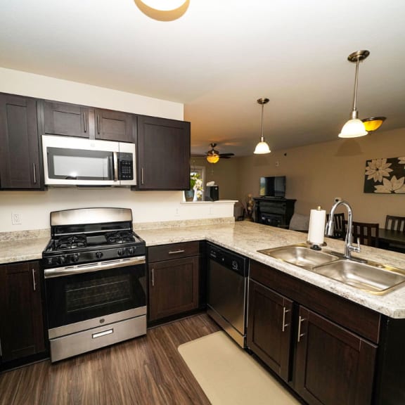 Thumbnail 8 of 15 A kitchen with stainless steel appliances at Copper Creek Apartment Homes, Maize