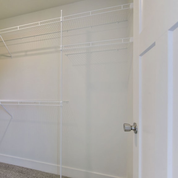 Thumbnail 12 of 14 Walk in closet with wardrobe organizers at Copper Creek Apartment Homes, Maize