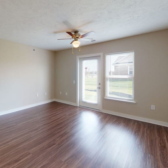 Thumbnail 6 of 14 Two bedroom living room with hard surface flooring at Copper Creek Apartment Homes, Maize