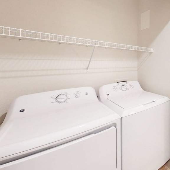 Thumbnail 9 of 14 a laundry room with washer and a dryer at Copper Creek Apartment Homes in KS 67101