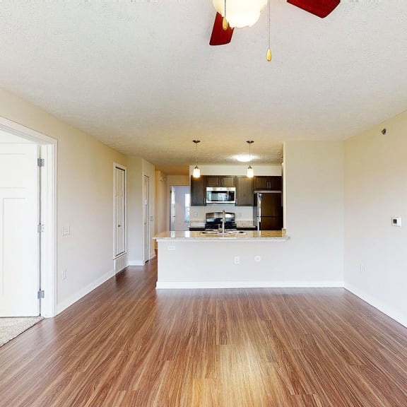 Thumbnail 7 of 14 Two bedroom living room and kitchen with hard surface floors at Copper Creek Apartment Homes in Maize, KS 67101