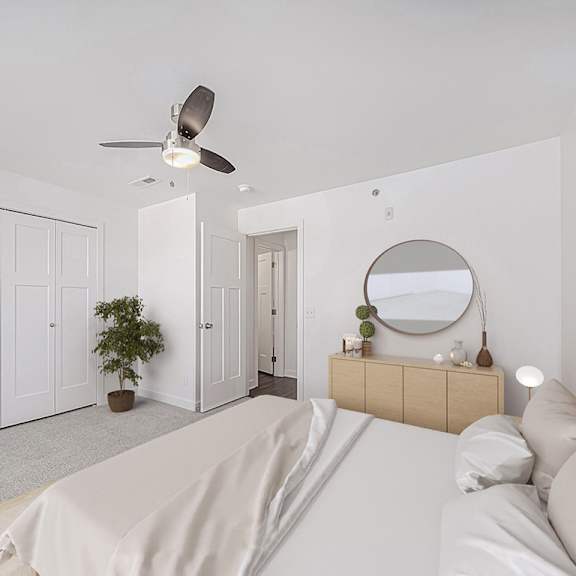 Thumbnail 9 of 9 Spacious bedroom with ceiling fan and modern dresser at Copper Creek Homes Apartments, Maize, KS 67101