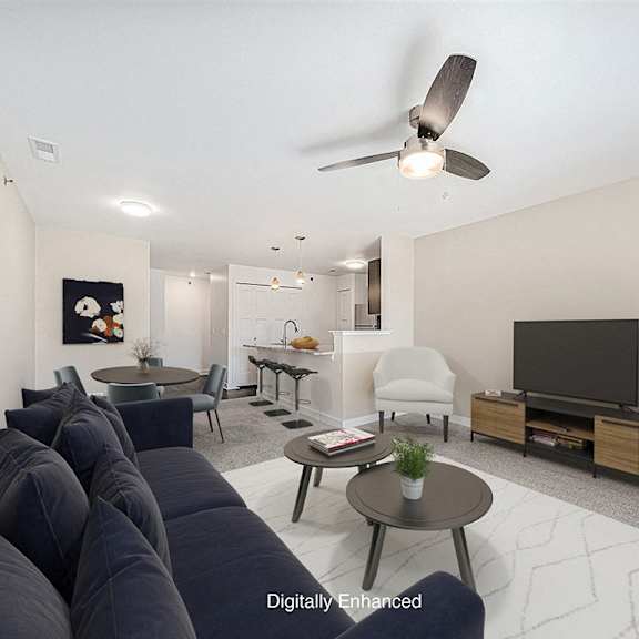 Thumbnail 4 of 15 A living room with a sofa and a television at Copper Creek Apartment Homes, Kansas, 67101