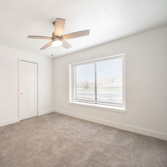 Thumbnail 7 of 8 Bedroom with ceiling fan at The Crossings Apartments, Grand Rapids, 49508