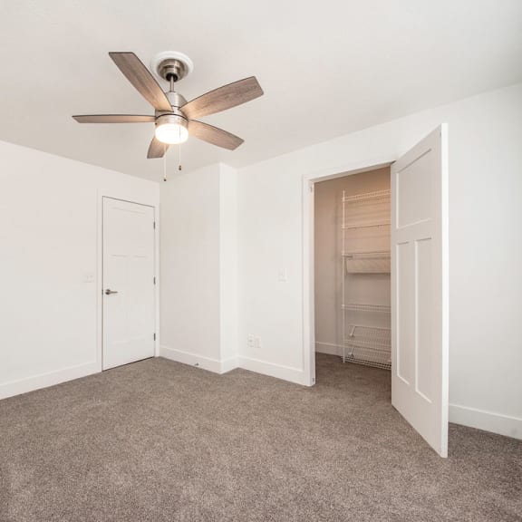 Thumbnail 8 of 8 Large living room with ceiling fan at The Crossings Apartments, Grand Rapids, MI