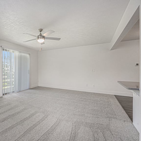 Thumbnail 7 of 13 Oversized living room leading to private balcony at The Crossings Apartments, Michigan, 49508