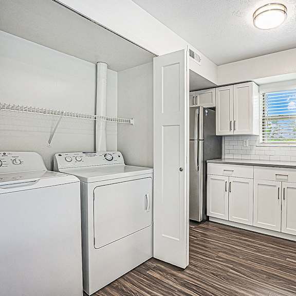 Thumbnail 9 of 13 A kitchen with a washer and dryer at The Crossings Apartments in Grand Rapids, MI