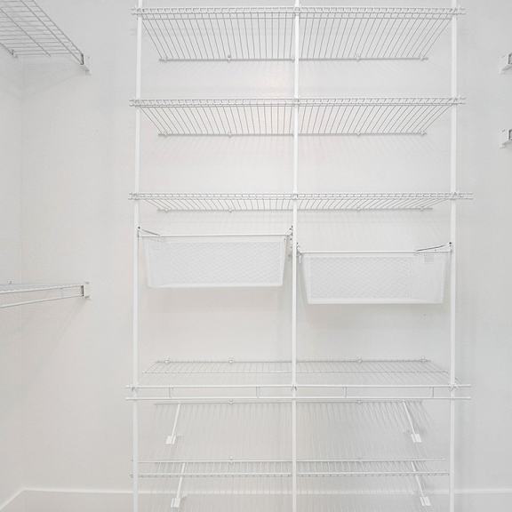 Thumbnail 16 of 16 A walk-in closet with wardrobe organizers at The Crossings Apartments, Grand Rapids