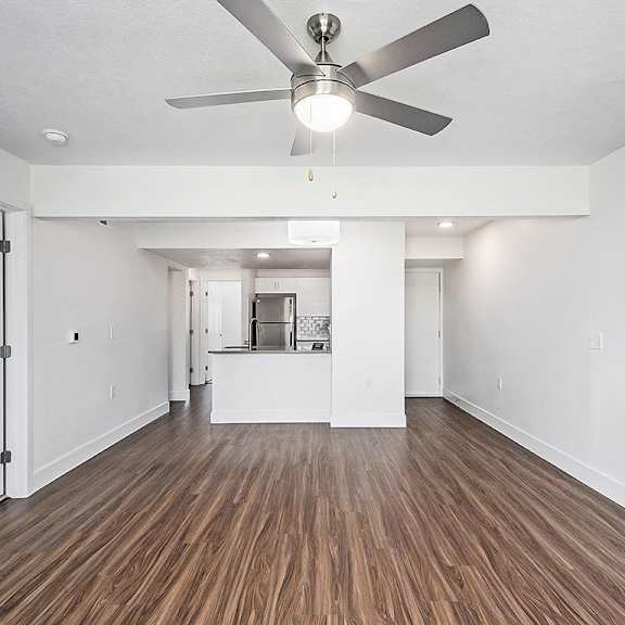 Thumbnail 4 of 15 A living room with a ceiling fan at The Crossings Apartments in Grand Rapids, MI