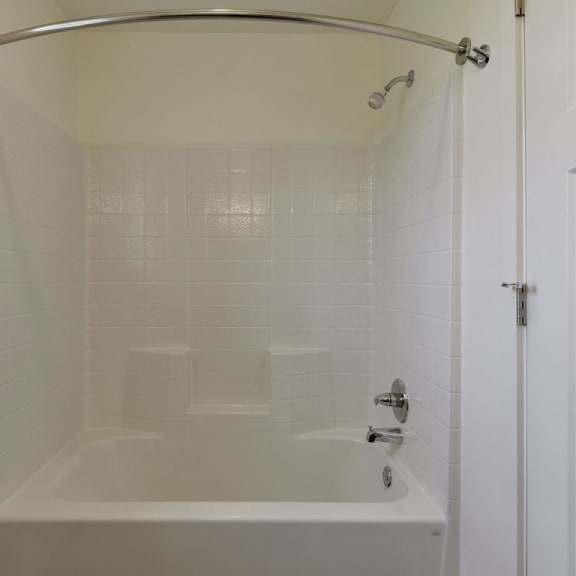 Thumbnail 10 of 12 A shower and bathtub combination at Dodson Pointe Apartment Homes, Rogers, AR